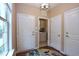 Welcoming entryway with a laundry room view, tile flooring, and white doors at 1033 Cuthbert Ln, Durham, NC 27703