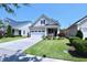 Charming home with a well-manicured lawn, inviting front porch, and attached two-car garage at 1033 Cuthbert Ln, Durham, NC 27703