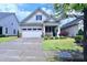 Charming single-Gathering home with a well-manicured lawn and inviting front porch at 1033 Cuthbert Ln, Durham, NC 27703