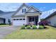 Well maintained single-Gathering home with an attached garage and landscaped front yard at 1033 Cuthbert Ln, Durham, NC 27703