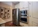 Kitchen with stainless steel refrigerator, microwave, and oven, complemented by hardwood floors at 1033 Cuthbert Ln, Durham, NC 27703