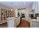 Modern kitchen with an island, stainless steel appliances, and hardwood floors at 1033 Cuthbert Ln, Durham, NC 27703