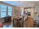 Open concept living and dining area with modern lighting and an island kitchen at 1033 Cuthbert Ln, Durham, NC 27703