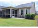 Relaxing patio with outdoor seating and access to a screened-in porch and yard at 1033 Cuthbert Ln, Durham, NC 27703