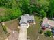 Aerial view of a well-manicured property showcasing landscaping, a spacious driveway, and mature trees at 108 Christy Circle Ln, Clayton, NC 27520