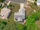 Aerial view of a home with a backyard deck, set amongst mature trees and well-manicured lawns at 108 Christy Circle Ln, Clayton, NC 27520