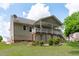 Backyard of a home featuring a covered deck, patio area, and well-maintained landscaping at 108 Christy Circle Ln, Clayton, NC 27520