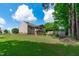 Expansive backyard features a well-maintained lawn, mature trees, and a large, covered deck at 108 Christy Circle Ln, Clayton, NC 27520