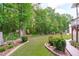 Expansive backyard showcasing lush greenery and mature trees, ideal for outdoor activities at 108 Christy Circle Ln, Clayton, NC 27520