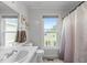 Bright bathroom with a white vanity, toilet, and shower/tub combination near a window at 108 Christy Circle Ln, Clayton, NC 27520