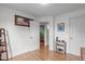 Bedroom showing a view into the kitchen, with wood floors and white walls with an open door at 108 Christy Circle Ln, Clayton, NC 27520