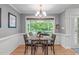 Inviting dining room with wood table, chandelier, wainscoting, and views of the screened porch at 108 Christy Circle Ln, Clayton, NC 27520