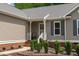 Charming home featuring a welcoming front entrance with a landscaped yard and traditional design elements at 108 Christy Circle Ln, Clayton, NC 27520