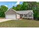 Charming home featuring a well-manicured lawn, mature landscaping, and an attached two-car garage at 108 Christy Circle Ln, Clayton, NC 27520