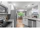 Spacious kitchen with stainless steel appliances, granite countertops, white cabinetry, and open dining area at 108 Christy Circle Ln, Clayton, NC 27520