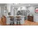 Kitchen featuring granite countertops, stainless steel appliances, modern lighting, and breakfast bar seating at 108 Christy Circle Ln, Clayton, NC 27520