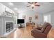 Spacious living room features a cozy fireplace, bright windows, and sleek hardwood flooring at 108 Christy Circle Ln, Clayton, NC 27520