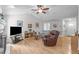 Bright living room features vaulted ceilings, a ceiling fan, hardwood floors, and a cozy seating area at 108 Christy Circle Ln, Clayton, NC 27520