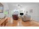 Open living room with vaulted ceiling, fireplace, hardwood floors, and large windows at 108 Christy Circle Ln, Clayton, NC 27520
