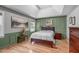 Stylish bedroom with tray ceilings, warm wood flooring, and ample natural light at 108 Christy Circle Ln, Clayton, NC 27520