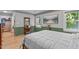 Bedroom featuring hardwood floors, a large window, and a built-in vanity area at 108 Christy Circle Ln, Clayton, NC 27520