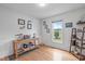 Bright office with hardwood floors, large window, and a wooden table with decorative items at 108 Christy Circle Ln, Clayton, NC 27520