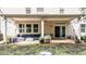 Cozy covered back patio featuring comfortable seating and stylish decor, perfect for outdoor living at 108 Yosemite Ct, Holly Springs, NC 27540