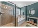 Bathroom featuring a glass shower, soaking tub, and teal painted walls at 108 Yosemite Ct, Holly Springs, NC 27540