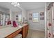 Bright bathroom featuring a vanity, makeup counter, tile floors, and a shower curtain at 108 Yosemite Ct, Holly Springs, NC 27540