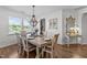 A wood dining table is set for dinner underneath a chandelier, next to a console table at 108 Yosemite Ct, Holly Springs, NC 27540