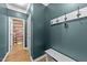 Stylish entryway with a bench, coat hooks, and view into the half bath at 108 Yosemite Ct, Holly Springs, NC 27540