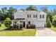Charming two-story home with a manicured lawn and welcoming front porch, great curb appeal at 108 Yosemite Ct, Holly Springs, NC 27540
