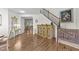 Inviting foyer with hardwood floors, staircase, decorative cabinet and art at 108 Yosemite Ct, Holly Springs, NC 27540