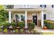 Inviting front porch with stone accents, rocking chairs and manicured landscaping for relaxation at 108 Yosemite Ct, Holly Springs, NC 27540