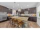 Gourmet kitchen boasts dark wood cabinetry, granite counters, island with seating and stainless steel appliances at 108 Yosemite Ct, Holly Springs, NC 27540