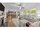 Open-concept living room with a fireplace, light grey couches, and an eat-in kitchen at 108 Yosemite Ct, Holly Springs, NC 27540