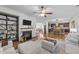 Open living room and kitchen featuring hardwood floors, fireplace, and modern ceiling fan at 108 Yosemite Ct, Holly Springs, NC 27540