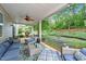 Relaxing covered patio featuring comfortable seating and views of the backyard with lush greenery and a playhouse at 108 Yosemite Ct, Holly Springs, NC 27540