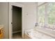 Large soaking tub with a window view and decorative display at 1097 Trentini Ave, Wake Forest, NC 27587