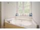 Oversized soaking tub with a decorative display and view at 1097 Trentini Ave, Wake Forest, NC 27587