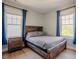 Cozy bedroom with rustic wood frame bed and natural light at 1097 Trentini Ave, Wake Forest, NC 27587