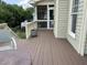 Relaxing outdoor deck area with ample seating and a screened-in porch for enjoying the outdoors at 1097 Trentini Ave, Wake Forest, NC 27587