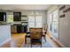Bright dining room with a wooden table, modern chandelier, and access to the kitchen at 1097 Trentini Ave, Wake Forest, NC 27587