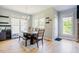 Bright dining room with hardwood floors, modern chandelier, and large windows with lots of natural light at 1097 Trentini Ave, Wake Forest, NC 27587