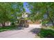 Beautiful home exterior with mature trees, lush lawn, a covered porch, and an attached garage at 1097 Trentini Ave, Wake Forest, NC 27587