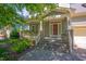 Attractive home featuring a welcoming covered porch, stone accents, and a well-manicured front yard at 1097 Trentini Ave, Wake Forest, NC 27587