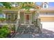 Inviting front entrance with stone steps, manicured landscaping, and a charming front door at 1097 Trentini Ave, Wake Forest, NC 27587