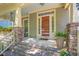 Inviting front porch with stone accents, a vibrant front door, and space for seating and potted plants at 1097 Trentini Ave, Wake Forest, NC 27587