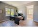 Bright office space with wood floors, ceiling fan, large desk, and a wall of windows at 1097 Trentini Ave, Wake Forest, NC 27587