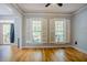 Inviting living room featuring hardwood floors, white shutters and view to the front porch at 1097 Trentini Ave, Wake Forest, NC 27587